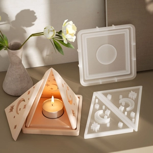 Macro view of pyramid resin candle holder with hollow moon and star patterns