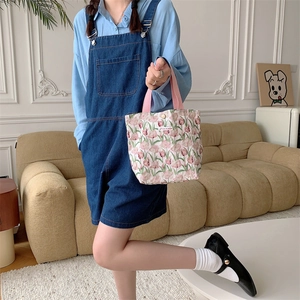 Dettaglio della piccola borsa in tela a fiori con tulipani rosa e chiusura a scatto