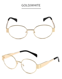 Detail of gold metal oval sunglasses with wide hinges and black acetate temple tips