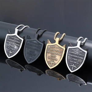 Detailed view of Saint Michael shield pendants in silver, gold, and black metal finishes