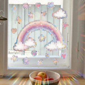 Rainbow prism window sticker casting colorful light patterns with clouds and stars