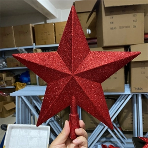Detail shot of a sparkling red five-pointed star topper with glitter finish for Christmas tree