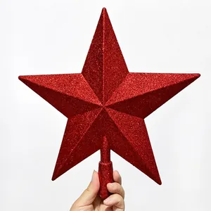 Detail shot of a sparkling red five-pointed star topper with glitter finish for Christmas tree
