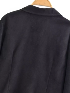 Close-up of the back neck and shoulder tailoring on a black velvet blazer for women