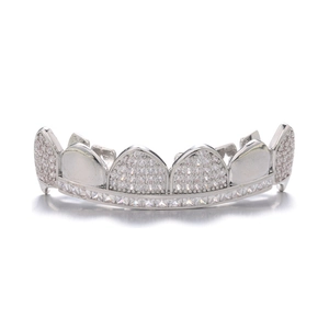 Close-up of hip hop silver grillz with full diamond encrusting and glossy reflection