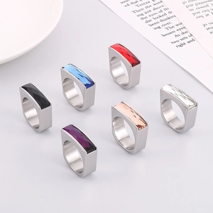 Macro view of six stainless steel rings with colorful rectangular gemstone inlays