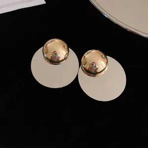 Minimalist geometric round metal earrings with golden dome and large circular disks