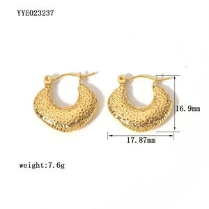 Vue macro de boucles d'oreilles croissant plaquées or 18 carats avec finition martelée