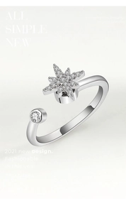 Macro view of rotating snowflake fidget ring with sparkling cubic zirconia on silver band