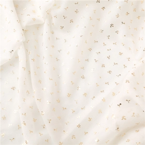 Close-up of white lightweight fabric with gold foil patterns and crinkled texture