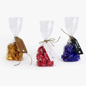 Three gift bags with red, gold and blue candies featuring Happy Birthday and Love tags
