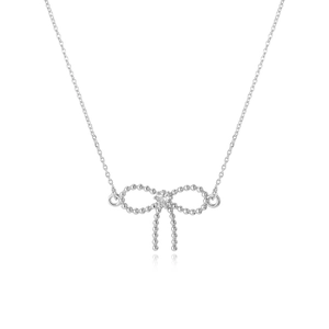 Detailed view of a silver bow necklace pendant with beaded texture and a center zircon