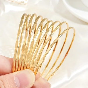 Set of 10 gold hammered bangles in minimalist bohemian style for elegant women