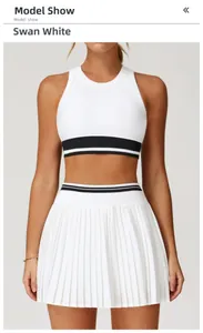 Detail of Swan White racerback sports bra and pleated skirt with striped hem on a model