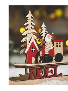 Detailed view of wood Christmas sleigh ornament with NOEL text and festive light backdrop