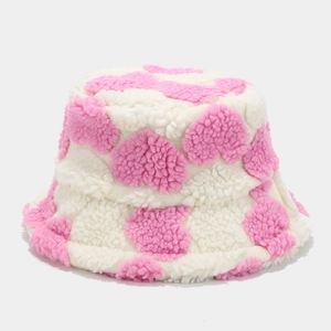 Close-up of thick plush sherpa fabric with heart pattern on winter bucket hat