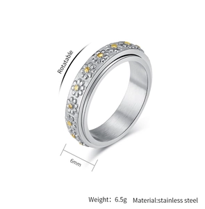 Detail of 6mm stainless steel spinner ring with rotatable daisy pattern and brushed finish