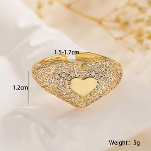 Macro shot of gold plated heart ring with sparkling zircons and adjustable band detail