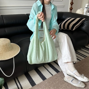 Detail of mint green tote bag with unique crinkle texture and large capacity design
