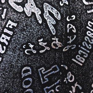 Macro view of black fabric with silver glitter finish and trendy street-style letter print