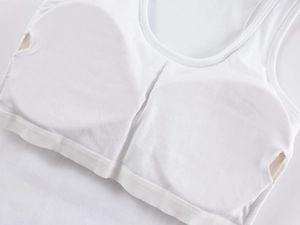Close-up of white padded sports vest showing inner pocket and soft knit texture