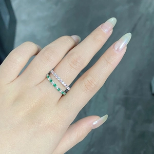 Close-up of elegant s925 silver rings with pink and green stones on a model's hand