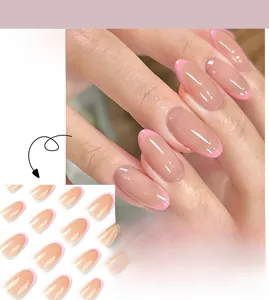 Detailed view of pink French style press-on nails with oval shape and glossy finish