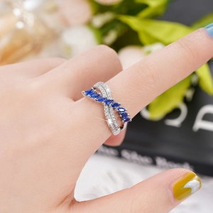 Macro detail of wave ring with marquise cut blue stones and micro-paved zircons