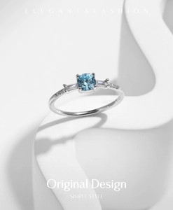 Detailed view of s925 silver ring featuring round blue stone and side trapezoid diamonds