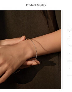 Close-up of minimalist S925 sterling silver beaded bracelet on a female wrist