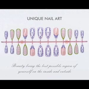 Unique almond press-on nails with blue vine patterns and 3D floral carvings