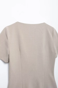 Close-up of the square neckline and structured shoulder seam of the khaki vintage shirt
