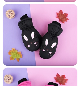 Close-up of waterproof children's ski mittens with cute rabbit patterns and elastic cuffs