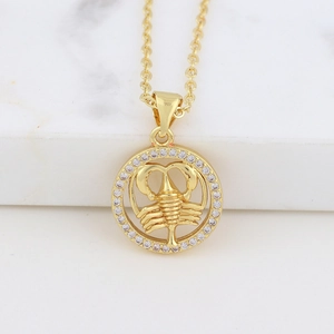 Detailed view of Scorpio pendant necklace in gold with shimmering cubic zirconia accents