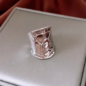 Irregular geometric textured wide open silver ring with a modern crumpled metal finish