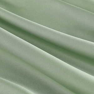 Detailed macro view of light green chiffon fabric showing smooth drape and silky texture