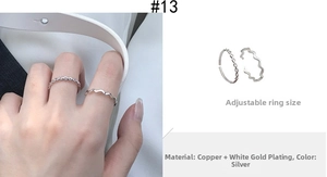 Detail of silver twisted and wavy open rings in copper with white gold plating