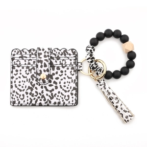 Close-up of leopard print card holder with beaded silicone bracelet and stylish tassel
