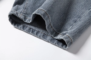 Close-up of star pattern denim shorts with contrast brown stitching and twill fabric texture