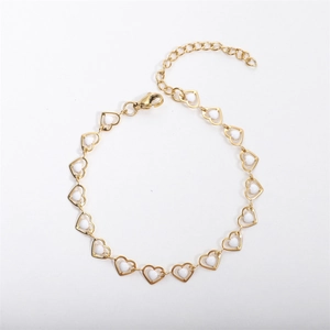 Detailed macro view of 18k gold plated chain featuring white heart-shaped charms and lobster clasp