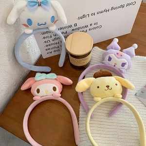 Detail of Sanrio characters plush headbands on a wooden table with home decor