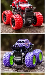 Macro shot of red and purple inertia 4WD monster truck toys on natural rocky terrain