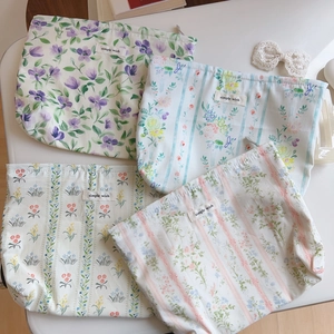 Detailed flat lay of cotton floral makeup bags with zip closure and Simple Wish label