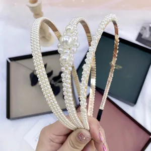 Three-piece gold metal headband set with elegant pearls and sparkling rhinestones