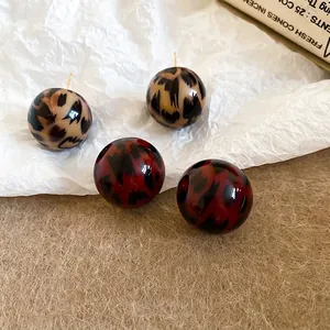 Elegant round resin leopard print stud earrings in brown and burgundy shades for women
