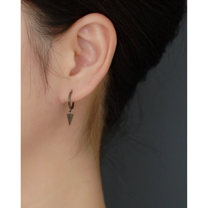 Close-up of S925 sterling silver geometric cone earrings on female model ear
