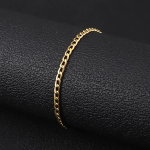 Close-up of a gold-plated stainless steel Cuban link bracelet on a black display stand