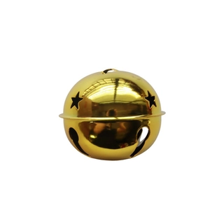 Close-up of an 8cm gold metal Christmas bell with star cutouts and a glossy finish