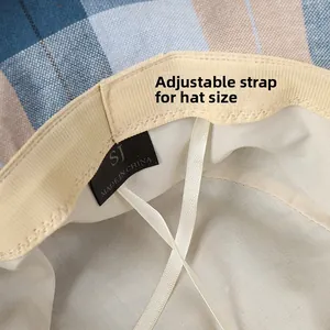 Detailed macro view of the inner adjustable drawstring and brand label on a checkered hat