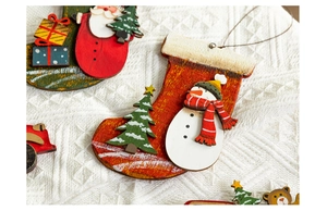 Detail of hand-painted wooden Christmas ornaments including snowman and festive socks